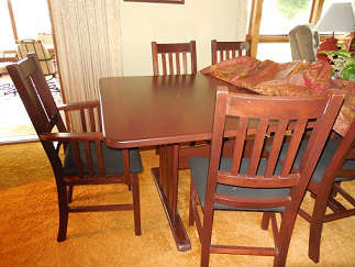 Arts a.nd crafts style dining table with leaf and 6 chairs.  The matching china cabinet is next