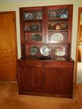 The arts & crafts style china cabinet with storage below and glass doors on top.