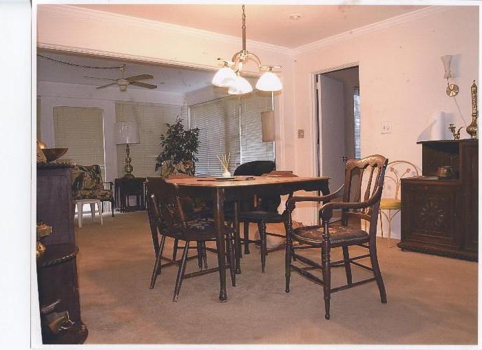 Vintage Oriental Style  Dining Set...includes Vintage Oriental Style Table with dark finish...6 vintage matching oriental style dining chairs (1High Backed Arm Chair, 5 Low Back Side Chairs) with spindled backs, nicely turned legs and braded needlepoint seats ; Also shown is Vintage Moroccan... Moorish Style  Server / Buffet...ornately carved, dark finish...top has carved rope style accents...2 cabinet doored storage...and  open shelf display /storage; Also shown is Vintage Oriental Style Hand Carved Bar...Camphor Wood with rich finish, Has Geisha Design Accents, Doored storage and a chiller area; Also Shown are Vintage Oriental Style Hand Carved Nesting Tables Set...Set of three all nicely carved.