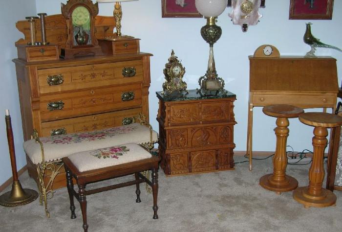 Antique furniture includes •	Dressers
•	Dropfront lady's writing desk
•	Wood pedestals
•	Needlepoint benches, footstools, wrought iron piano stool, ice cream chairs
•	Carved chests
•	Commodes
•	Rockers
•	Tea cart
•	Wicker chaise
•	Hall tree
•	Ice cream table and chairs
•	Butler's coffee table
•	3-door glass front display cabinet
