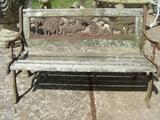 Vintage iron and wood childs bench with native African animals, in iron, on the back of the bench. 21" x 34".