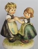 Lot#:	38
Description:	Hummel # 353 / 0 "Spring Dance" Goebel Trademark 6
An adorable porcelain figurine featuring two young Bavarian girls holding hands and dancing. One girl has a floral wreath in her hair. The bottom of the base is marked with the blue Goebel trademark 6. Incised on the rim of the base is "M. I. Hummel". First modeled in 1962 by a combination of sculptors. Figurine measures 5.5" tall. Free of chips, cracks, repairs.
Berta Hummel’s nickname was the “Hummelchen” (little bumble-bee). In 1934 she entered the Franciscan Abbey as Sister M. Innocentia. Her drawings depict kids just as they run about their native Bavarian village streets. Her sketch art caught the eye of Franz Goebel, porcelain maker and head of W. Goebel Porzellanfabrik, Germany. Goebel acquired rights to turn Hummel's drawing into figurines, producing the first line in 1935. These lovable street urchins never lose their youth and are as bright and vivid as on the very first day of issue. They bring life an