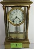 Lot#:	1
Description:	Antique Seth Thomas Mercury Beveled Glass Clock
Handsome large brass and beveled glass mantle clock signed Seth Thomas on the enamel face. The key wind clock features Arabic numeral hour markers and original elegant Victorian minute and hour hands. Mercury balanced pendulum. The bottom of the pendulum is etched, "29588/S". Circa turn of the century, the brass movement is marked with the letters "ST" in a circled diamond. The glass front and back both open for easy access to the movement and winding. The winding key is included in this lot. The outer case has an Olympian Greek design with columns / pillars at all four corners of the glass. Working condition of the clock has not been determined. Measures 14" tall x 8" x 6".