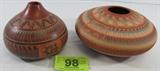 Lot#:	98
Description:	2 Signed Contemporary Southwest Incised Pottery
Gorgeous lot of 2 hand signed contemporary Southwestern style, Native American Indian incised etched potteries. These pieces of pottery are made from red terracotta clay and painted on the wheel while the clay is still soft. The designs are than hand cut through the paint layer into the raw clay pot; after being fired the score lines become part of the design showing the earth-colored red background. Adorned with Southwest symbols and designs such as circular feather arrangements and geometric border patterns. They are hand signed by artist “T. K. L. Navajo 2004”. Each piece is in excellent condition free of chips, cracks or repairs. Lot features:
- Seed pot, measures 9.5” in diameter x 5” tall
- Vase titled “Dine”, measures 6.75” in diameter x 6” tall
Tag words: Southwest 
ZB3513