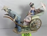 Lot#:	400
Description:	Retired Lladro "Ride In China" #01001383 LARGE
A breath taking LARGE Lladro hard-paste porcelain figurine, "Ride in China", Model No. 01001383. Issued in 1978 and retired in 2005, this figural group figurine was designed by sculptor Salvador Debon. Figure is marked on the bottom with the blue Lladro backstamp. The figurine has a glazed finish and features a Chinese Courtesans (equivalent to a Japanese Geisha) with umbrella seated in a rickshaw which is being pulled by a young Chinese man. Th figurine is in excellent condition with no chips or breaks. Measures 11.75" tall x 14.5" long. Don't miss out on this true collector's piece.