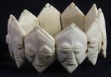 Lot#:	332
Description:	Jewelry, Carved Ivory Tribal Face Stretch Bracelet
Gorgeous vintage carved ivory / bone tribal stretch style bracelet. It features individual elongated hexagon shaped heads with carved facial details set onto a double strand of elastic. Excellent condition, one small blemish the back of one charm. Unknown maker or origin; possibly Africa. Item is being listed as ivory (possibly bone) according to the information provided by the consigner. To the best of our knowledge the consignor's statement is true. Measures: 7” circumference but stretches larger. 
To see similar items up for auction see lot #'s 7, 61, 137, 161, 206, 244, 288
ZB152 