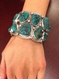 Lot#:	5
Description:	Jewelry Large Sterling Turquoise Bracelet Signed
Outstanding large sterling silver cuff bracelet with Southwestern / Native American Indian style design. Featuring several large sawtooth set Natural Nevada turquoise stones. Band is accented with raised and pressed patterns. Marked / signed "CH", measures: 5.75" around with 1.25" opening x 2.25" wide. Total weight: 4.64 ozt. 
ZB5435
