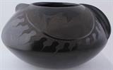 Lot#:	224
Description:	Genuine Tonala Barro Negro Black Pottery; Mateos
Stunning large Southwest style Tonala Barro Negro (Black Pottery) pot. Attributed to “La Familia Mateos”, this beautiful, handcrafted museum quality shaped olla is burnished to a soft sheen with incised moon motifs done by hand using needles and saws to dig out formations and designs; a technique called “esgrafiado”. This black-on-black bowl is created by a method of firing pottery in a low oxygen environment to create a blackened, opulent look. It has something to see at every angle and is a superb example of traditional Barro Negro pottery; it would make a wonderful addition to your Southwestern collection. Incised mark on the bottom reads “Mateos Mexico”. It is in excellent condition with no chips, cracks or repairs. Measures 6" tall x 9.5" in diameter.
From the internet: "Rigoberto Mateos Ortega, born in 1942, was an artist in barro negro esgrafiado and passed his trade down to his family. Although for many yea