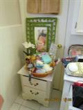 2-Drawer Night Stand; Green Wicker Mirror; Bath Accessories.