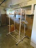 Two metal clothes racks on casters.