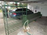 Green Wrought Iron Shelf. Green, long, wood church pew bench. Boat Anchors.