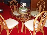 Rattan Table with Round Glass Top and Four Chairs.