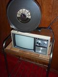 Old TV with handle. Disc Antenna with dial, cool. 
Several TV Stands.