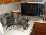 Many small kitchen appliances, including microwave.