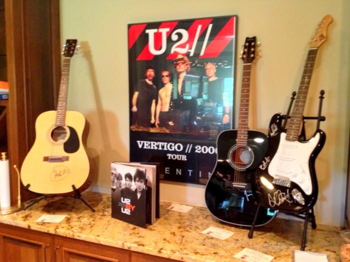 Guitars signed by U2, John Mayer and James Taylor.  Bono-signed U2 Poster