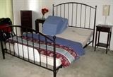 Adjustable Queen size electric bed without mattress. Crate and Barrel metal bedframe. Mahogany nightstands.