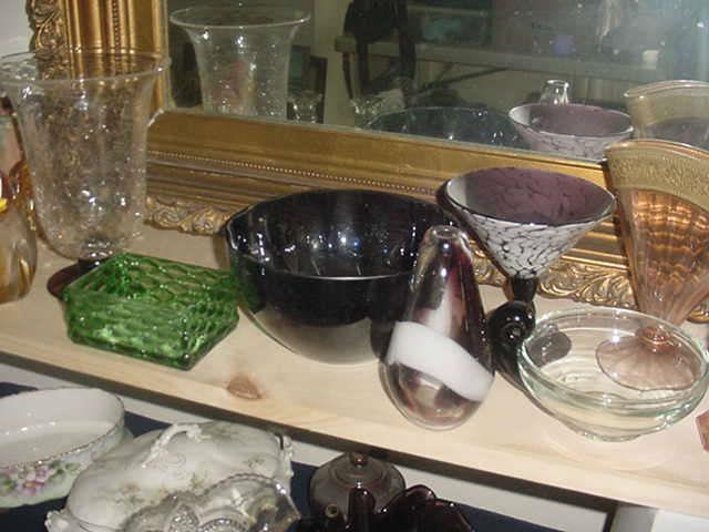 The green glass bowl is from the 16th Century of China, the bowl on the far right with the :bird handle is Steuben, as is the dark glass bowl, and others as well.