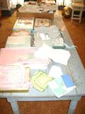 Thrasher's table covered with vintage small children's clothing