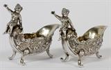 Lot#1039, EUROPEAN .800 SILVER SHELL-FORM SALTS, C. 1900, PAIR, L 3", PROBABLY ITALIAN//A set of 2 Rococo style .800 silver shell-form salts, each has a putto seated at the rim, stamped at the front leg "800 F.B.".  Totaling approximately 3.9 troy oz.