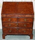 Lot#1048, ENGLISH WALNUT SLANT-FRONT DESK, 18TH C., H 36", W 31"/Top open to reveal a writing surface, with small pull out drawers and slots, below having two smaller drawers and two large drawers. Brass hardware and key hole escutcheons. Depth 18". Original old back boards. Interior fitted with stepped drawers and envelope slots. Original brasses. Nice small size.