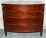 Lot#1049, SHERATON MAHOGANY BOW-FRONT CHEST, C. 1830, H 39", W 43",American chest. Having four graduated depth drawers, with wood knobs, and key hole escutcheons.  D 22". Spiral corner columns.