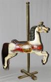 Lot#1064, VINTAGE CARVED & PAINTED WOOD CAROUSEL HORSE, C. 1900, H 46", L 51"Attributed to Charles Wallace Parker. Vintage carousel horse, circa 1900. jumper with open mouth, glass eyes horsehair tail. Height of brass  pole 79".