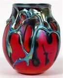 Lot#1084, CHARLES LOTTON ART GLASS VASE, 1978, H 5" DIA 4 1/2"Red art glass with an iridescent drip. Signed and dated at underside.