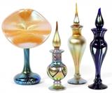Lot#1094, CORREIA & CARLSON, IRIDESCENT GLASS PERFUME BOTTLES (3) & A VASE, 1978-1979, H 6"-7"Includes 3 Correia perfume bottles, two having a yellow and lavender iridescent sheen, dated 1979 and 1978, the other made up of semi transparent cobalt blue glass, dated 1979; together with 1 Carlson Jack in the pulpit style glass vase, having a blue and lavender iridescent sheen, decorated in green pulled feather design.