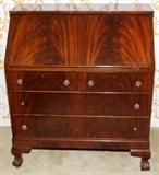 Lot#1174, MAHOGANY SLANT FRONT DESK, H 41", W 36", D 20"On claw and ball feet. Beautifully marked Honduras mahogany. Slant front opens to two drawers and envelope slots. Circa 1920, Empire Revival.