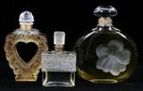 Lot#1326, LALIQUE CRYSTAL PERFUME BOTTLES, THREE, H 4 1/2"-6 1/2", FOR NINA RICCI & MOLINARD/Including, for Nina Ricci, 1 "Coeur-Joie", and 1 "Fleur de Fleurs", together with 1 for Molinard de Molinard; each is signed and fitted in its original box.