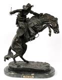 Lot#2064, AFTER FREDERIC REMINGTON, BRONZE SCULPTURE, H 22" L 18", "BRONCO BUSTER"Signed at base, edition #2/50. Raised on a black marble base. Measuring H. 22 1/2" x 18".