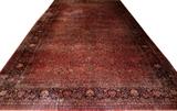Lot#2243, SAROUK PERSIAN MANSION CARPET, W 14' 10", L 27' 3"Persian Sarouk, red field, navy border, closed floral motif. Circa 1930.