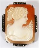 Lot#39, CARVED CAMEO BROOCH, H 1 1/2"carved cameo with faceted metal chips at the edges.