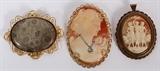 Lot#43, CAMEO BROOCHES AND PETOSKEY STONE BROOCH 3 PCS. H 2" - 2 1/4"two cameo brooches with gilt metal frames one depicting three female figures, 2" H. one of a female with an inserted plated metal necklace, 2 1/4" H; one oval polished Petoskey stone brooch with a gilt metal scroll work frame, 2 1/4" H.
