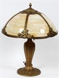 Lot#47, SLAG GLASS AND GILT METAL TWO-LIGHT TABLE LAMP, H 21", DIA 17"Having a nice gilt metal base with a caramel slag glass shade accented by floral and leaf designs.