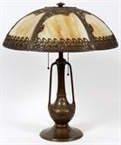 Lot#48, AMERICAN ART NOUVEAU STYLE SLAG GLASS TABLE LAMP, H 24", DIA 19"Circa 1930's.  Having caramel colored glass mounted in vine design pierced metal frame.