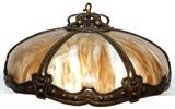 Lot#50, ARTS & CRAFTS, CARAMEL SLAG BENT GLASS HANGING FIXTURE, C. 1910, H 12", DIA 25"Art glass six bent glass panels. Hand hammered brass frame. Circa 1910.  Plus chain. Six lights.