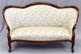 Lot#54, VICTORIAN MAHOGANY LOVESEAT, C. 1860, H 38", L 64", D 30"having carved and contoured back rest frame, arm rests, front seat frame and legs. Newer floral upholstery with white ground.