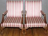 Lot#62, BAKER ARM CHAIRS, PAIR, H 41", W 29", D 34"carved walnut arm chairs with pink striped upholstery, brass nail trim, carved leaf design arm rests and legs, claw and ball feet, on casters.