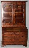 Lot#64, AMERICAN EMPIRE MAHOGANY SECRETARY DESK/BOOKCASE, C 19TH C, H 87", W 52", D 18"with bookcase on top with glass framed doors with pierced lattice work trim opening to three shelves all above three small drawers across the front along with slant top opening to felt top writing surface and cubicles across the back of the compartment. Two half width drawers above two full width drawers across the bottom. Bracket feet.