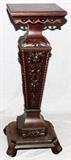 Lot#68, CARVED MAHOGANY PEDESTAL, H 40", L 14", D 14"having a square top with pierced semi-circular skirt, tapered square pedestal with carved leaf designs in relief, narrowing to a smaller square base all resting on a larger integral footed base.