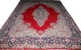 Lot#70, PERSIAN ORIENTAL WOOL CARPET, W 9', L 13' 5"having a red ground, six borders and a central medallion.