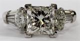 Lot#88, 3.01CT PRINCESS CUT DIAMOND RING, GIA, SIZE 7.25//Platinum ladies ring, featuring a 3.01 carat princess modified brilliant cut diamond at center, flanked by 1.00 carats of marquise side diamonds, and 0.76 carats of baguette side diamonds. Measuring approximately 10.3 grams in total weight, size 7.25. GIA report included. The princess cut diamond has a G-color, SI-1 clarity grading, with the side diamonds having a G-color, VS-2/Si-1 grading.
