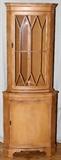 Lot#192, ENGLISH TWO-DOOR CORNER CABINET H 71", L 26", D 18.5"//The upper section features a glass door, with wood grill, which reveals two glass shelves.  The lower door opens to reveal one shelf.  Marked Made In England.