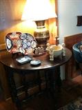           drop leaf table; Asian decor; brass lamp