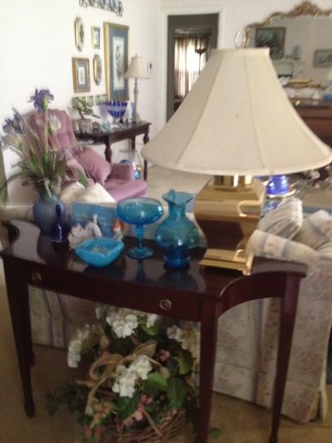 sofa table with many nice blue art glass pieces