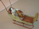 Antique china head, very small mohair bear in antique doll sled