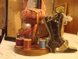 Early pincushion and spool caddy with Victorian leather boot pincushion
