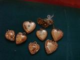 Tiny Victorian heart lockets and a tiny flower pin -
