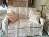 One of a pair floral love seats